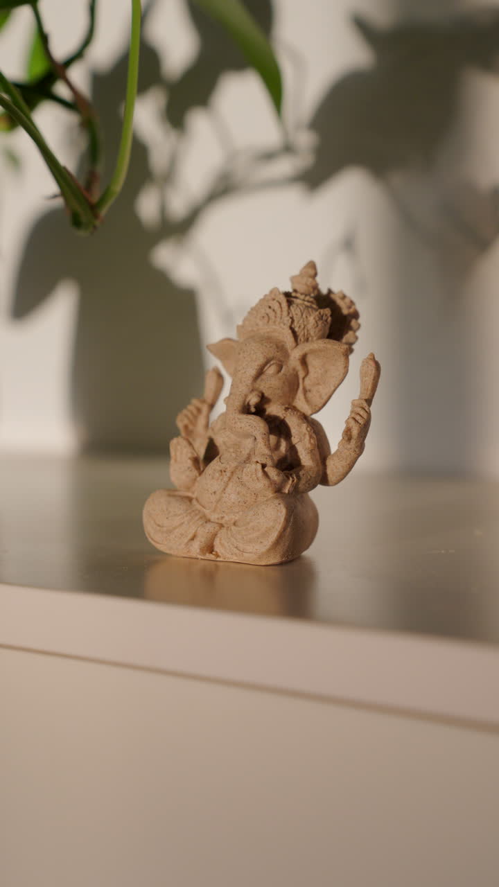 Ganesha statuette decor on a shelf, symbolizing good luck, prosperity, wisdom, and obstacle removal in a serene setting