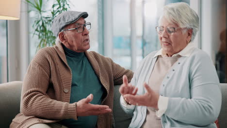 an elderly couple having a conversation at home