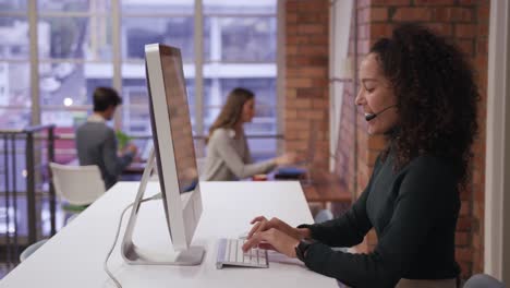 creative businesswoman wearing headset talking in modern office