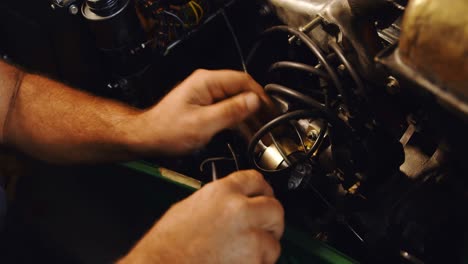 male mechanic servicing a car in garage 4k