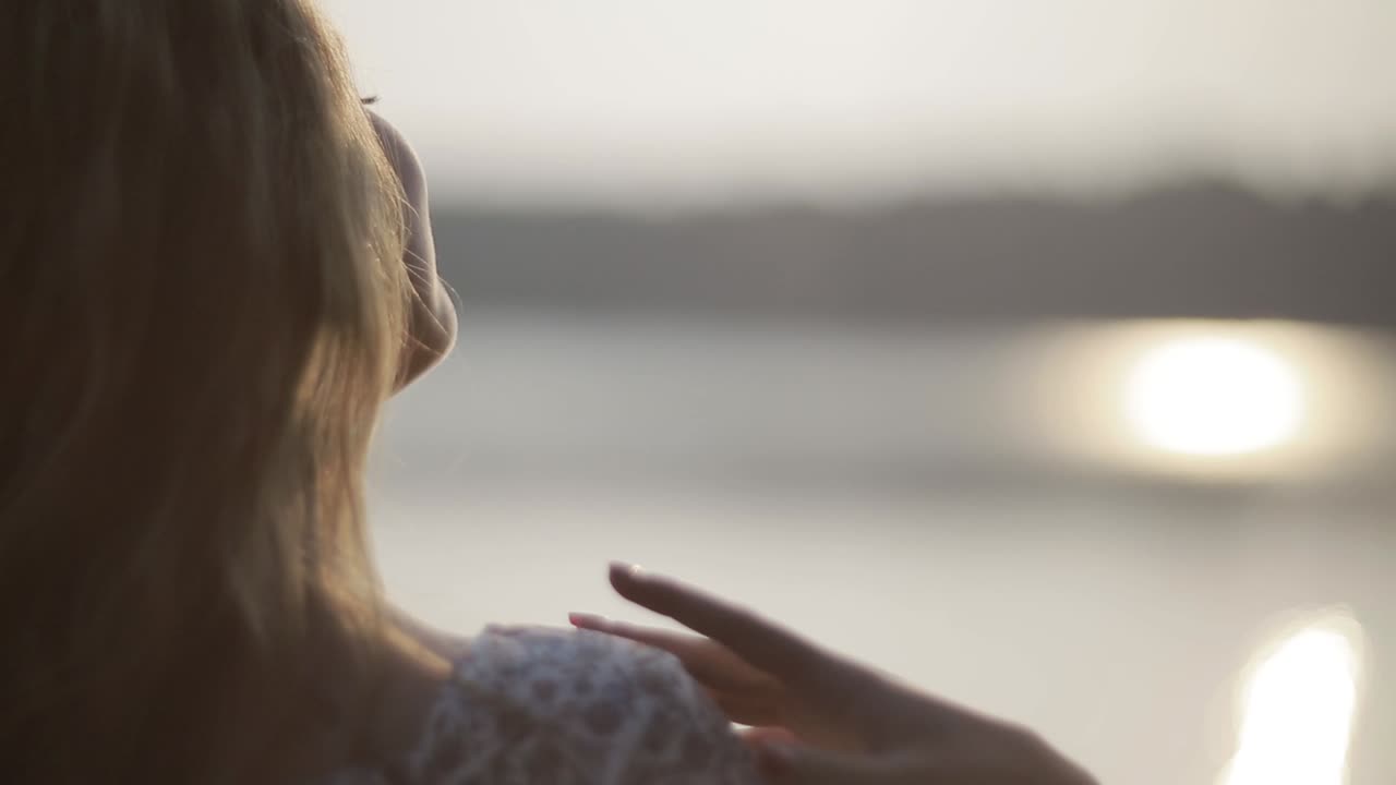 Dreaming Girl With River On Background. Woman relaxes by the lake, sunny joyful summer day or evening concept