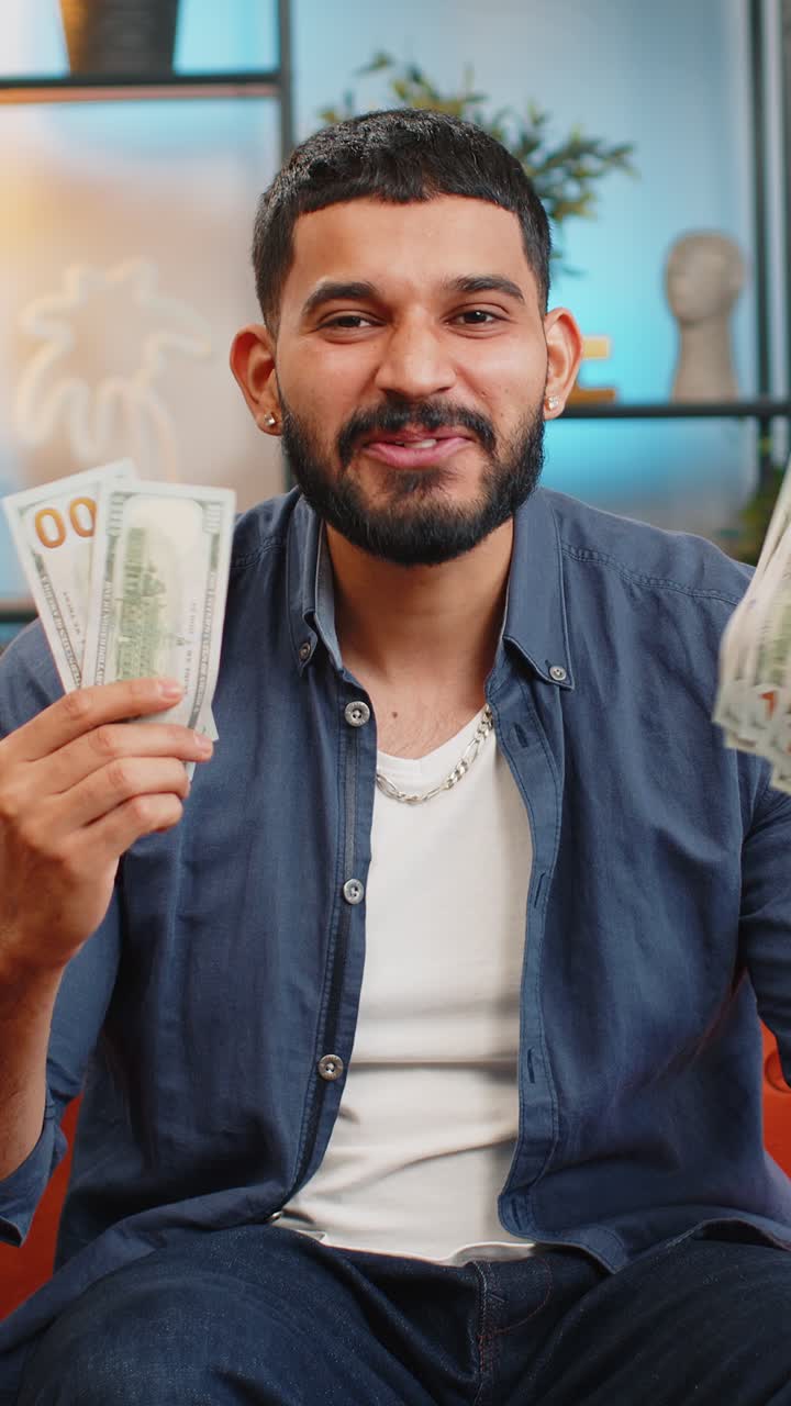 Excited happy arabian man showing money dollar cash bills satisfied of income saves salary earnings