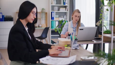 Two-Female-Office-Workers-Concentrated-on-Work