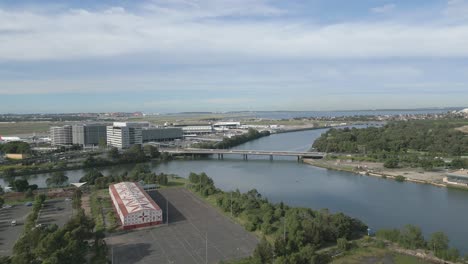 Aerial-zoom-in-view-towards-highway-and-bridge-near-the-airport