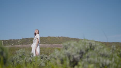 woman in a white dress in a natural landscape