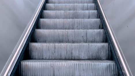 metal escalator steps in motion inside a modern public space