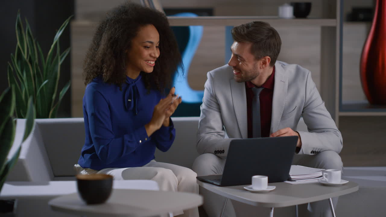 Multiracial colleagues video calling leading presentation showing graph in cafe.