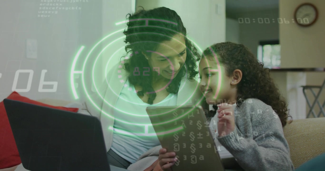 Smiling mother and daughter tapping tablet on living room couch, with laptop and HUD overlay