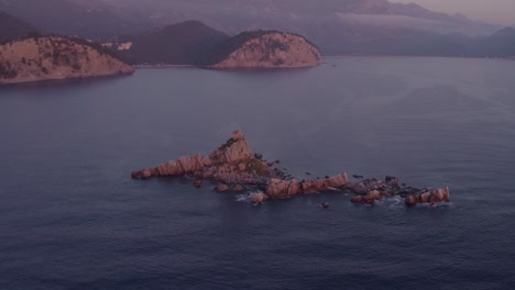 Orbit-around-St-Nedjelja-Church-at-Montenegro-during-magical-sunset,-aerial