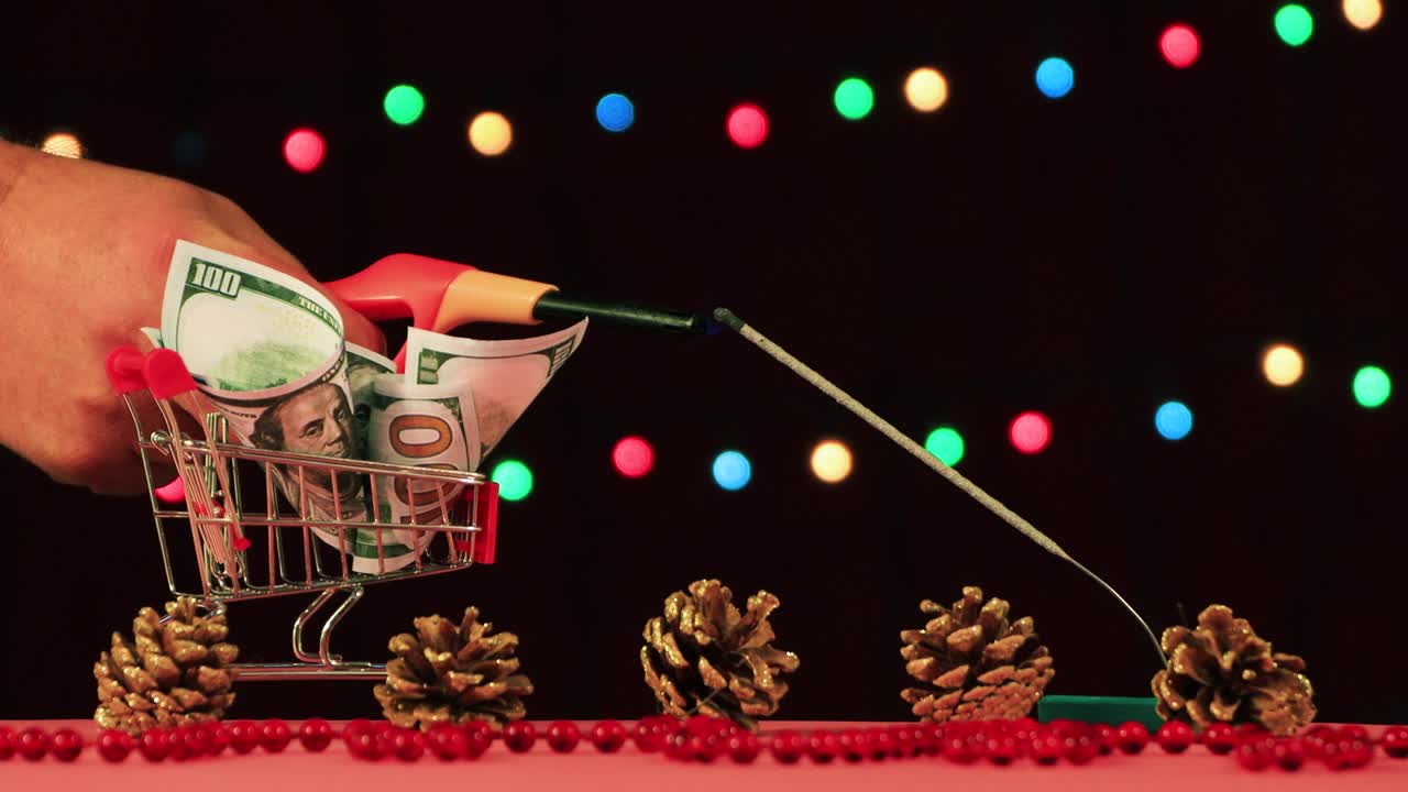 Close-up of a man's hand lights a Christmas sparkler.
