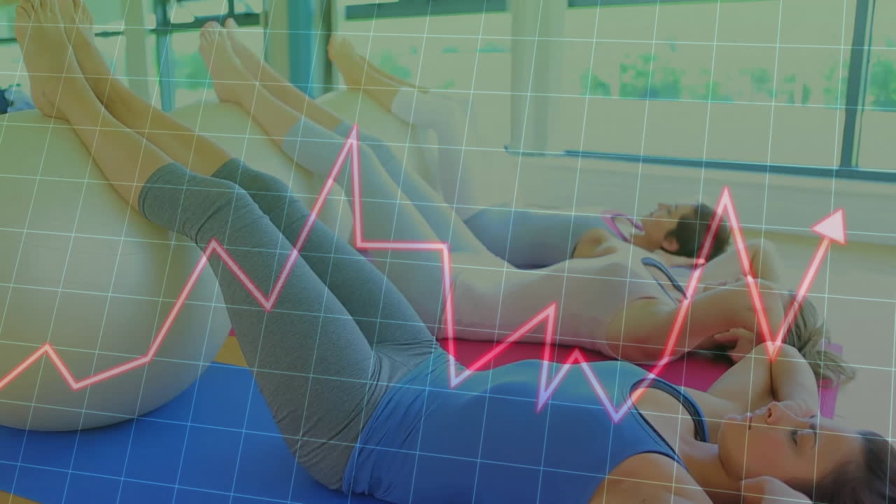 Group women performing ab crunches in fitness studio, with animated grid and heart-rate graph
