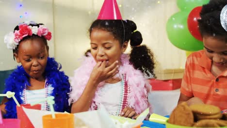 Animation-of-snow-falling-over-diverse-children-with-party-hats-at-birthday-party