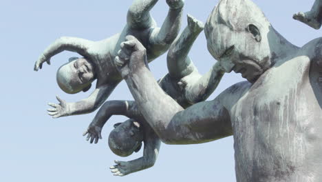 pan reveal to the babies of the sculpture, man under attack from evil spirits