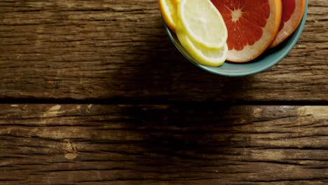 various citrus slices in bowl on wooden floor 4k 4k