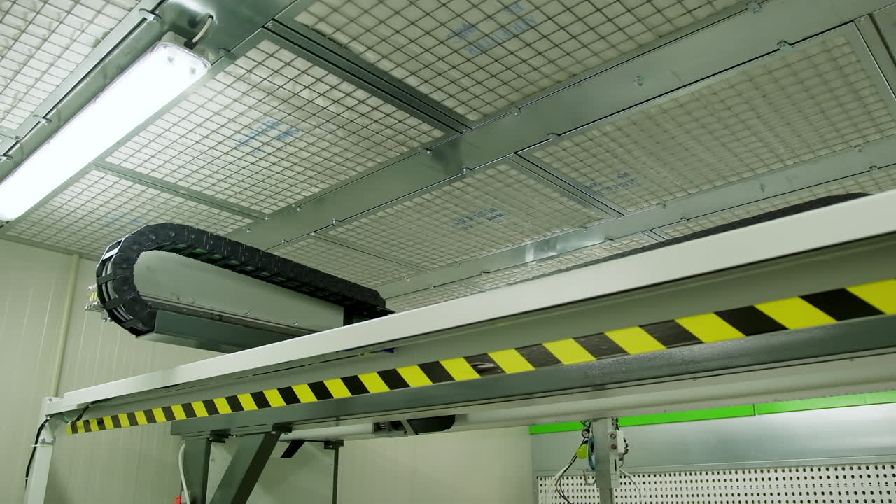 Robotic machine moving inside the plant. Automated device for door production in a modern workshop.