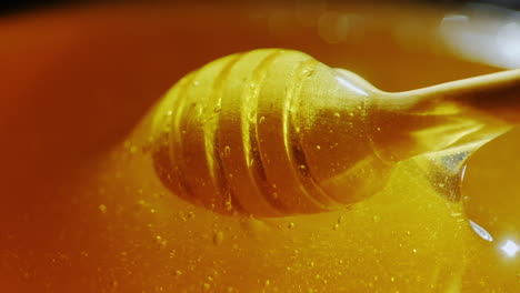 dunk a wooden spoon in honey slow motion video