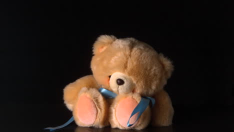 Cute-teddy-bear-falling-on-black-background