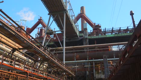 tilt shot of large factory preserved due to the testimony of ferrous metallurgy and industrial revolution by unesco - völklingen, saarbrücken, germany