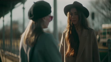 Women-Talking-at-Train-Station