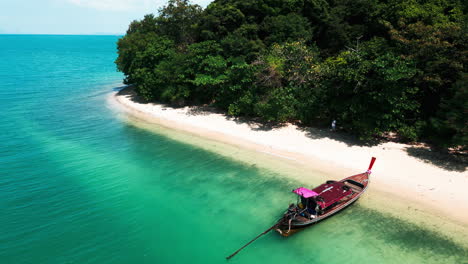 tropical island beach with longtail boat