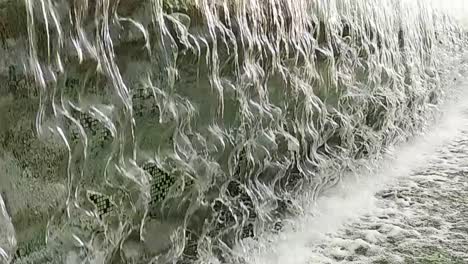 close-up or fountain water drops to small pool in the city