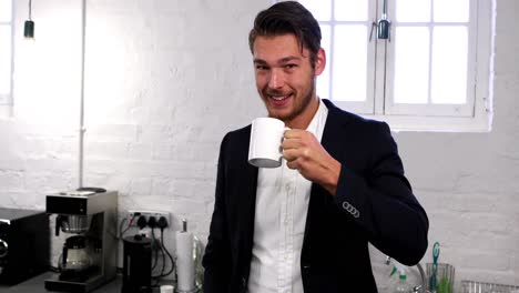 Handsome-businessman-having-a-coffee-break