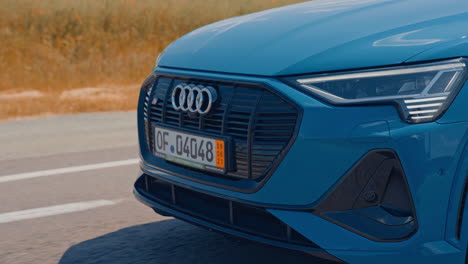 presentation of a blue audi e-tron, compact luxury crossover suv. modern new cars for sale