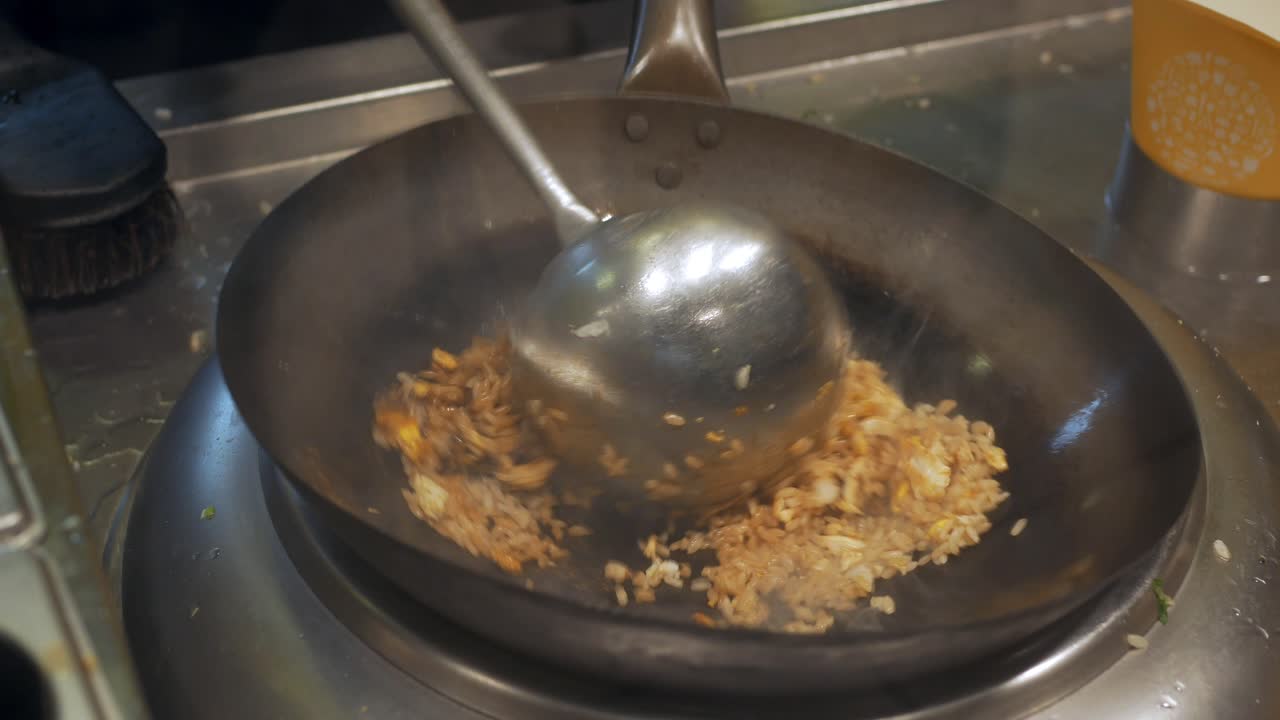 Chef preparing fried rice in a wok
