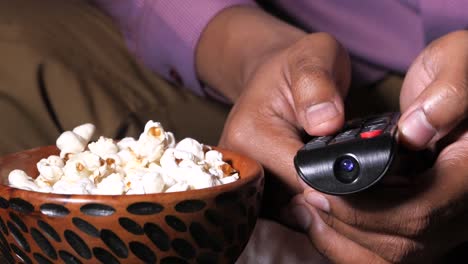 man watching tv with popcorn