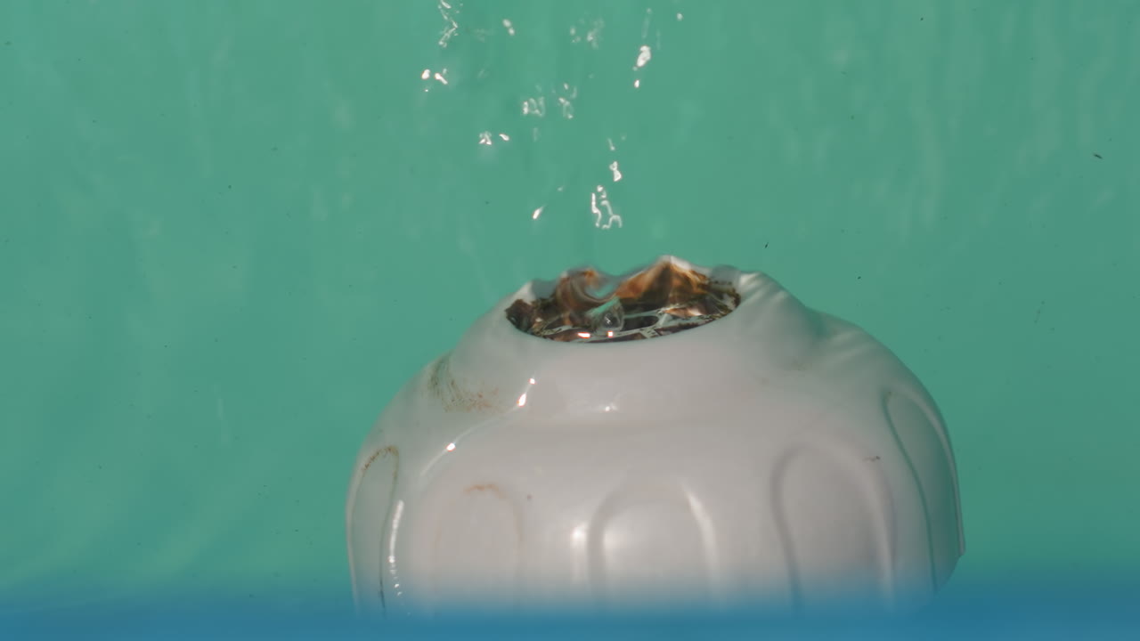 Gentle Water Flowing Over Porcelain Surface, Tranquil Aqua Spilling Over Smooth White Ceramic Container, Peaceful Scene Of Bubbling Teal Liquid In Clean Ceramic Vessel With Soft Studio Illumination