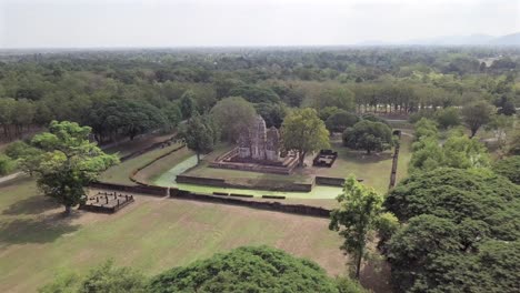 thailand,aerial view forward towards wat si sawai temple surrounded by vanfoss at sukhothai national park.