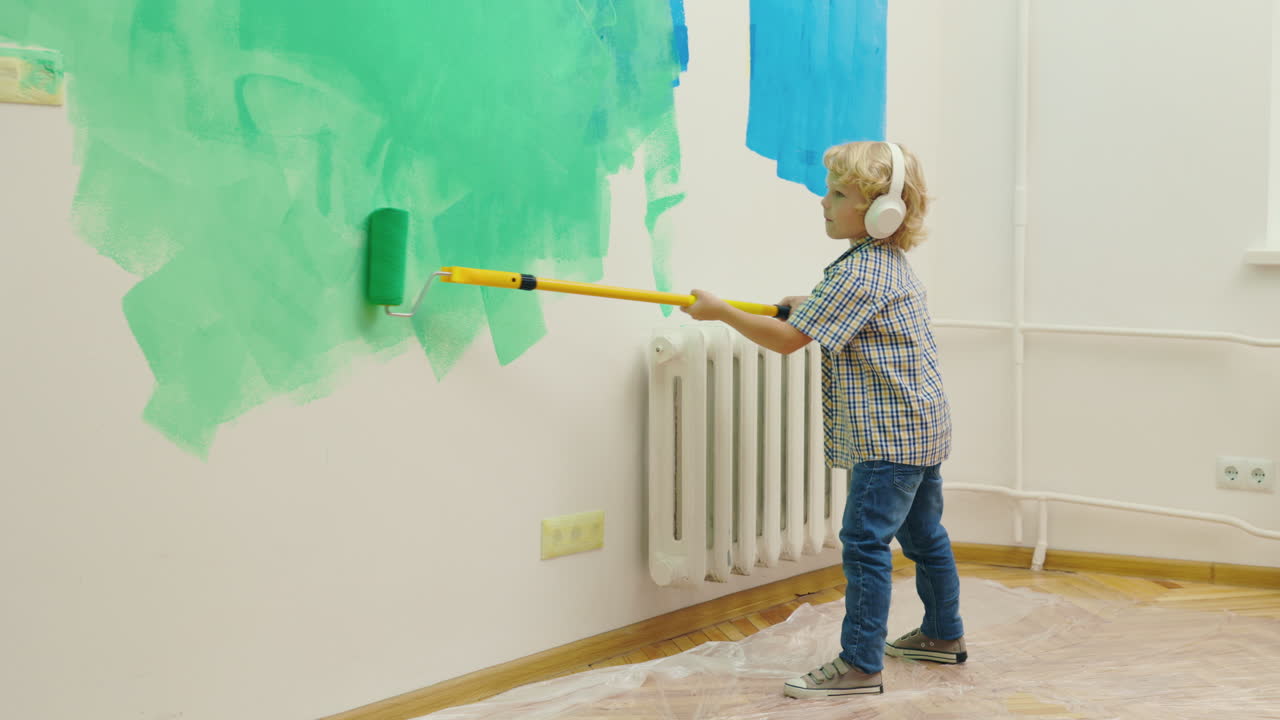 Child Painting Wall with Paint Roller