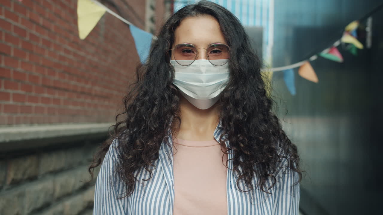 Woman Wearing a Mask in an Urban Alleyway