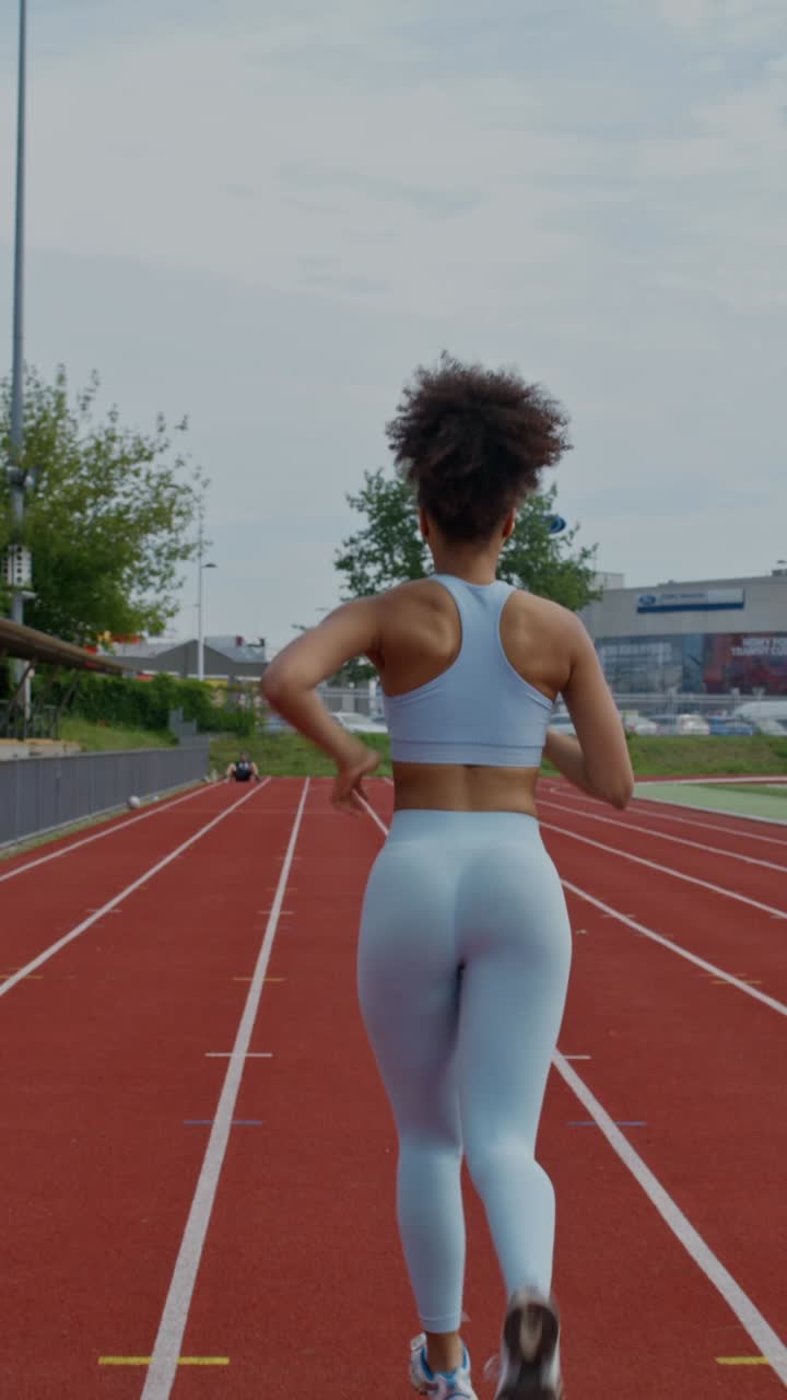 Woman Running on a Track
