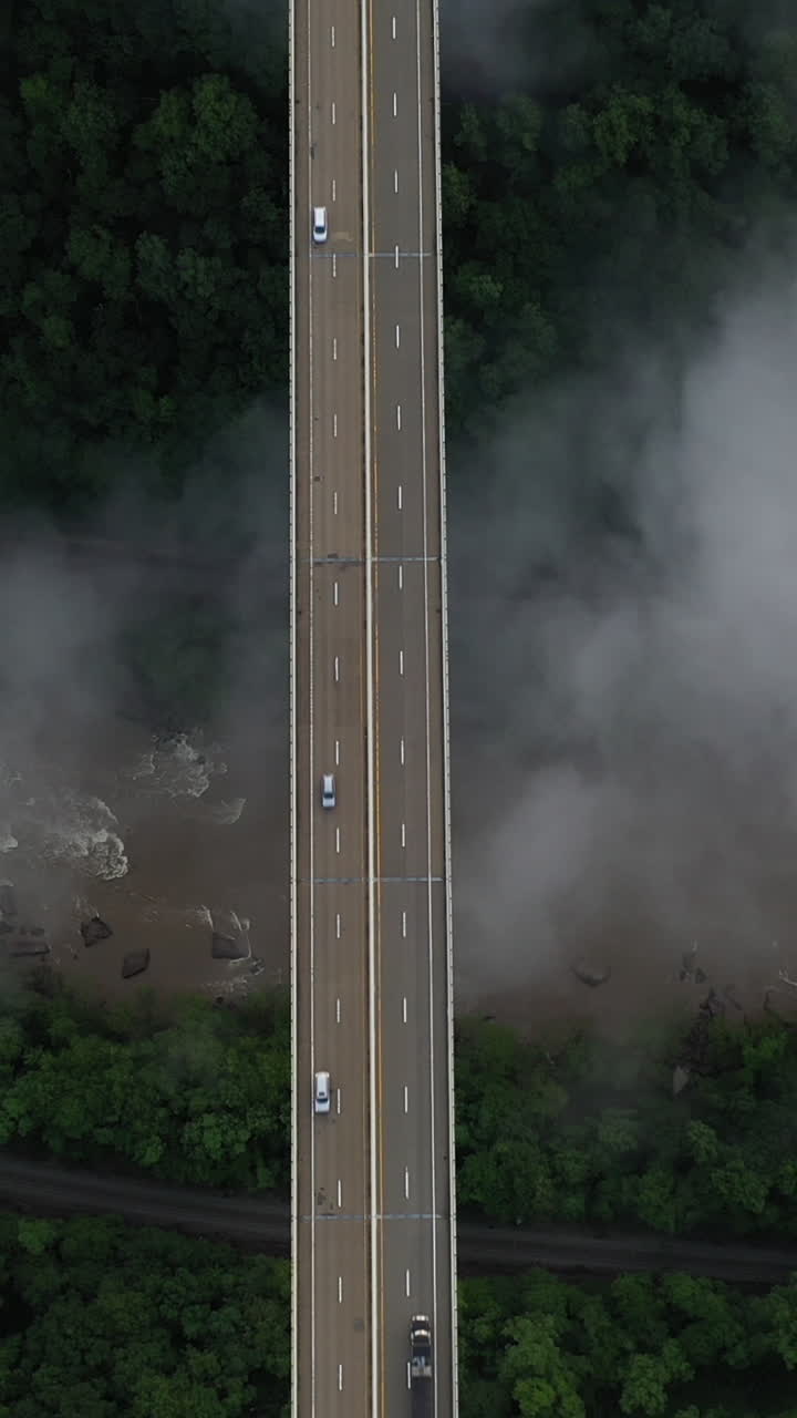 Vertical Drone Shot of Bridge Traffic Above Deep New River Gorge and Clouds, West Virginia USA