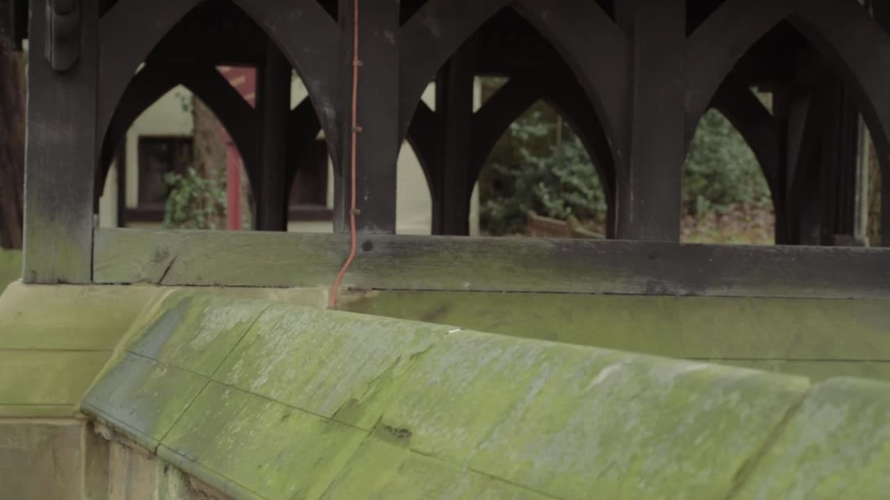Lych gate entrance at English Church with moss covered stone wall