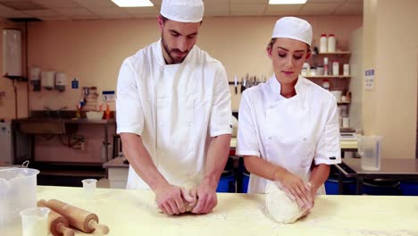 culinary students kneading dough together