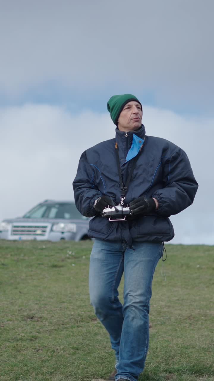 Man with remote control outdoors