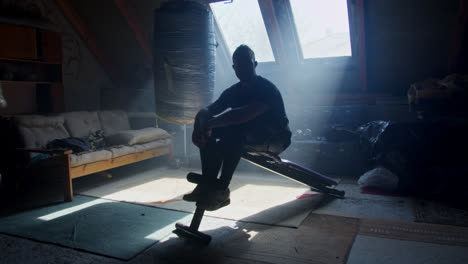 man working out in a home gym attic