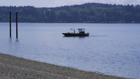 small, nondescript fishing floating near dock at camano island state park, wa state 15sec-24fps slow motion