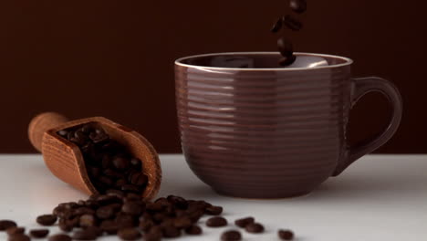 Coffee-beans-pouring-into-brown-cup