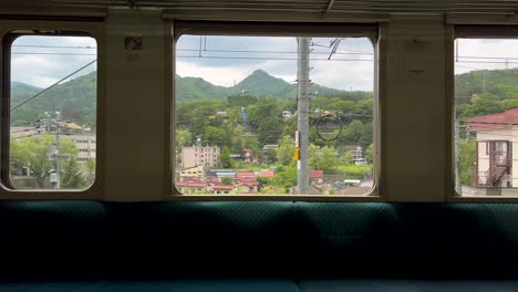 rural countryside passing outside train window in japan