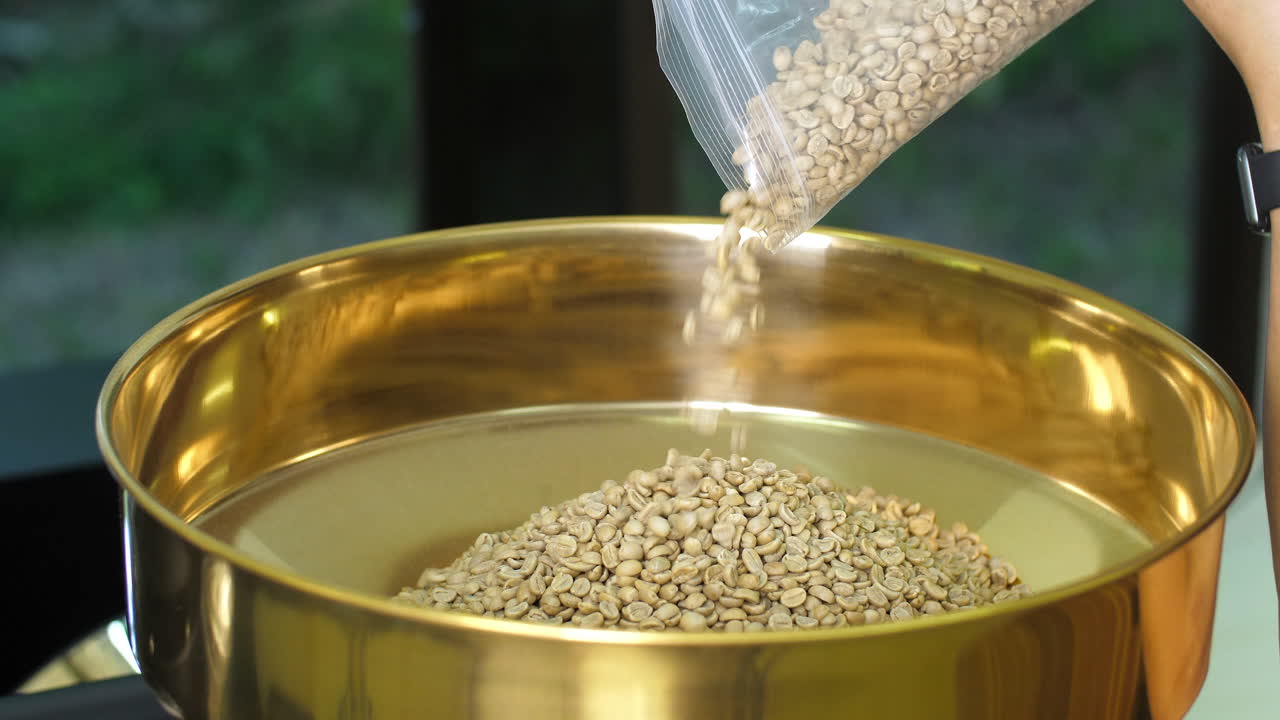 Pouring Raw Coffee Beans Into A Modern Machine