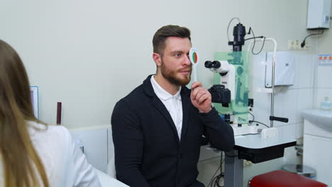 man examined by ophthalmologist. man in optical clinic having ophthalmologist examination