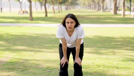 tired and exhausted indian woman in a park in morning