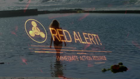 red alert text animation over person walking into ocean water