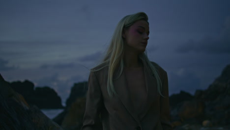 woman silhouette evening beach at cloudy sky closeup. flashing light on model