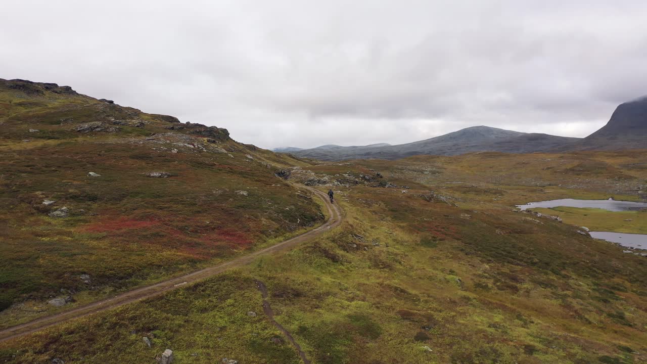 Inquadratura cinematografica di un mountain biker nella tundra norvegese
