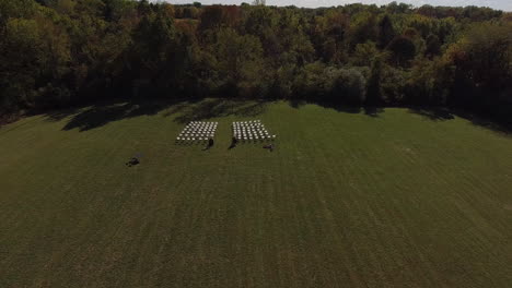 aerial shot of outdoor wedding venue setup with chairs, cinematic drone shot