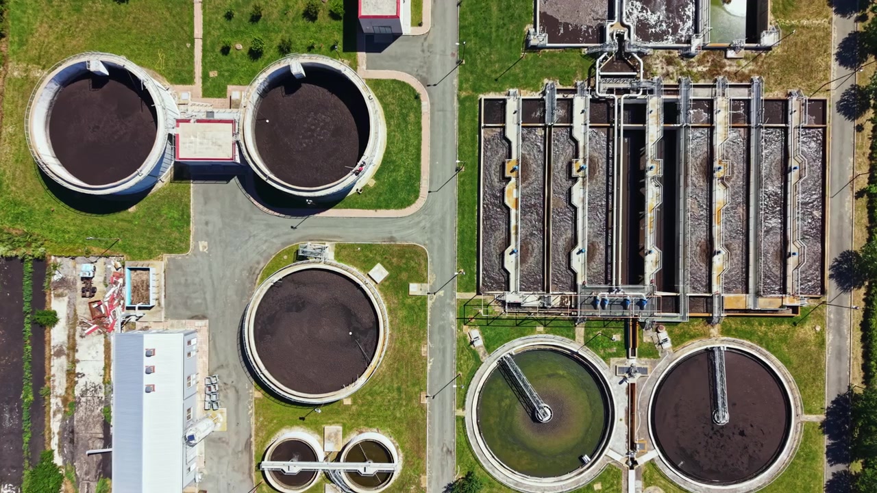 Water treatment facility shows tanks and processing areas in a clear layout under sunlight